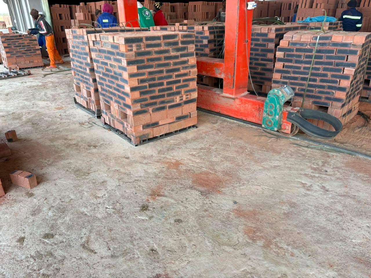 Bricklayer building a red brick wall